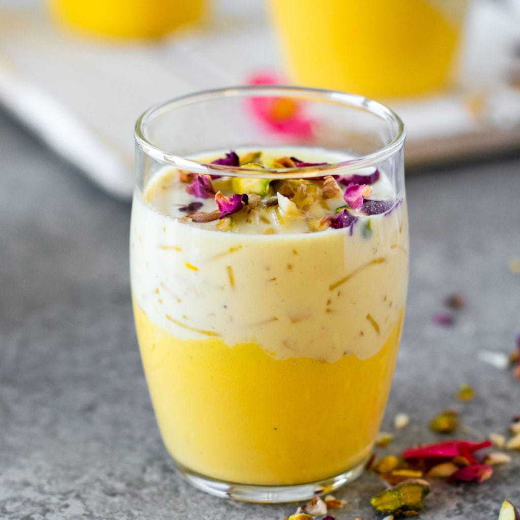 Kheer set with mango panna cotta in a small glass cup.
