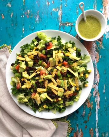 Vegan mexican salad with chopped kale and santa fe dressing