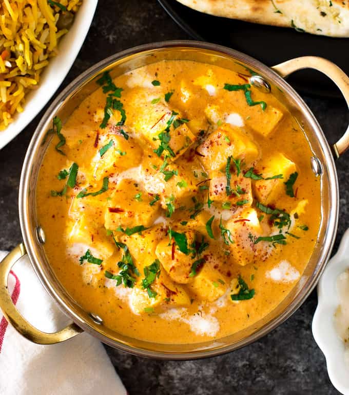 Shahi Paneer served in an Indian bowl besides rice. 