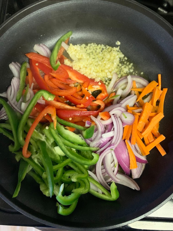 Peppers, carrots, onion and garlic in the pan.