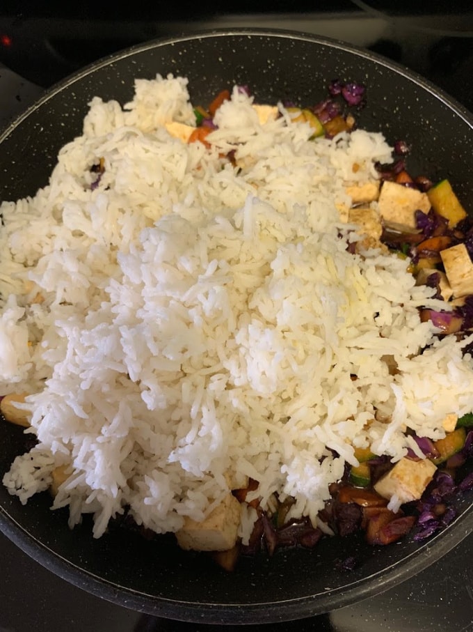 Adding rice to the pan.