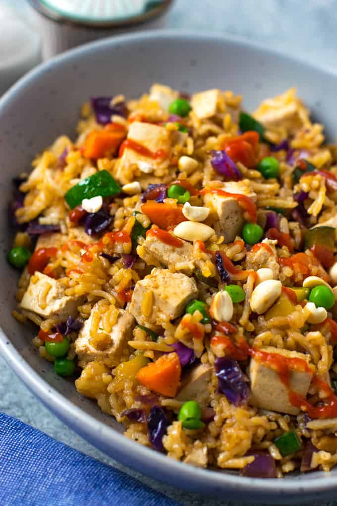 Vegetable fried rice drizzled with hot sauce. 