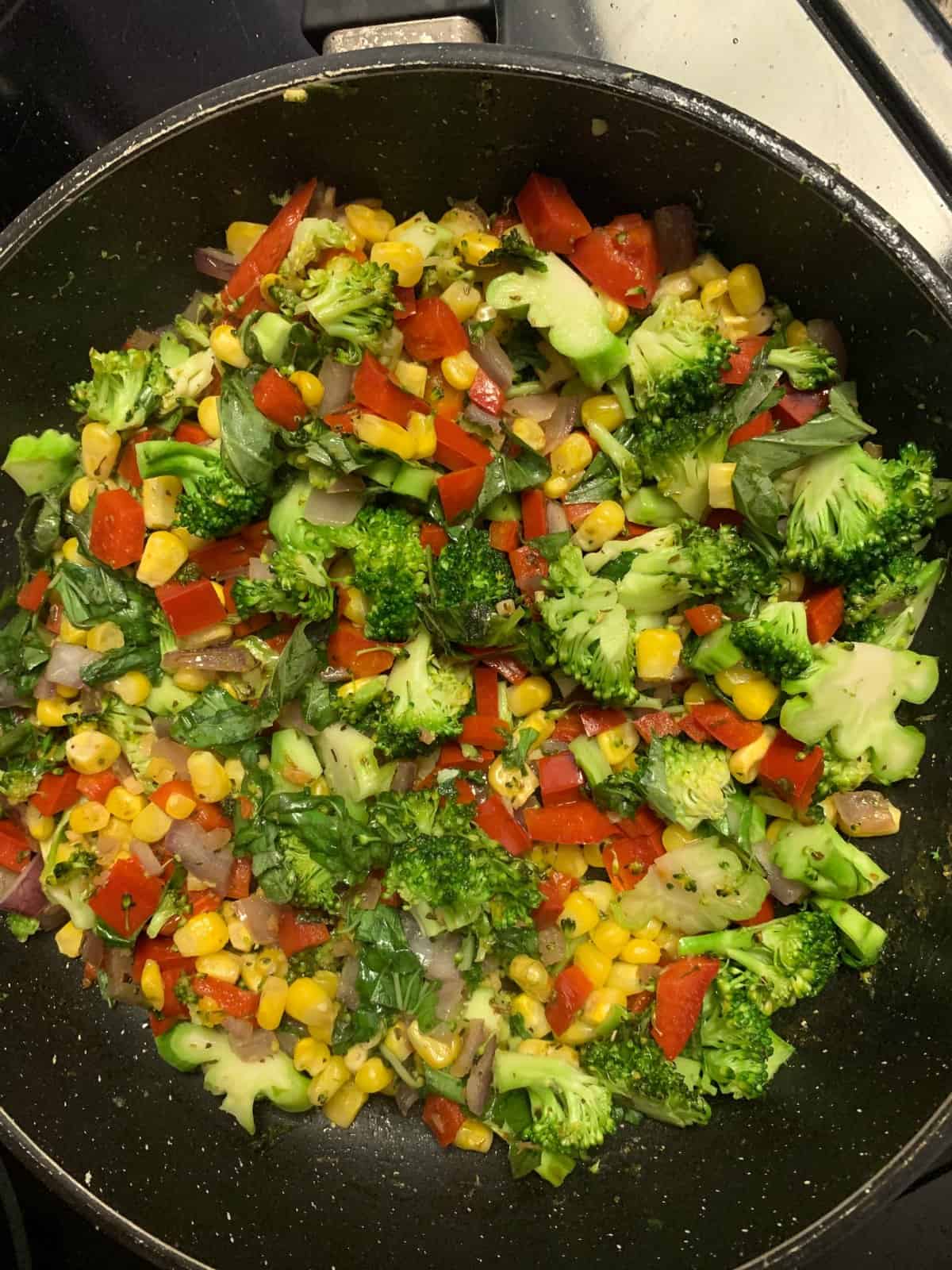 Mixed veggies like broccoli, peppers and corn in a pan