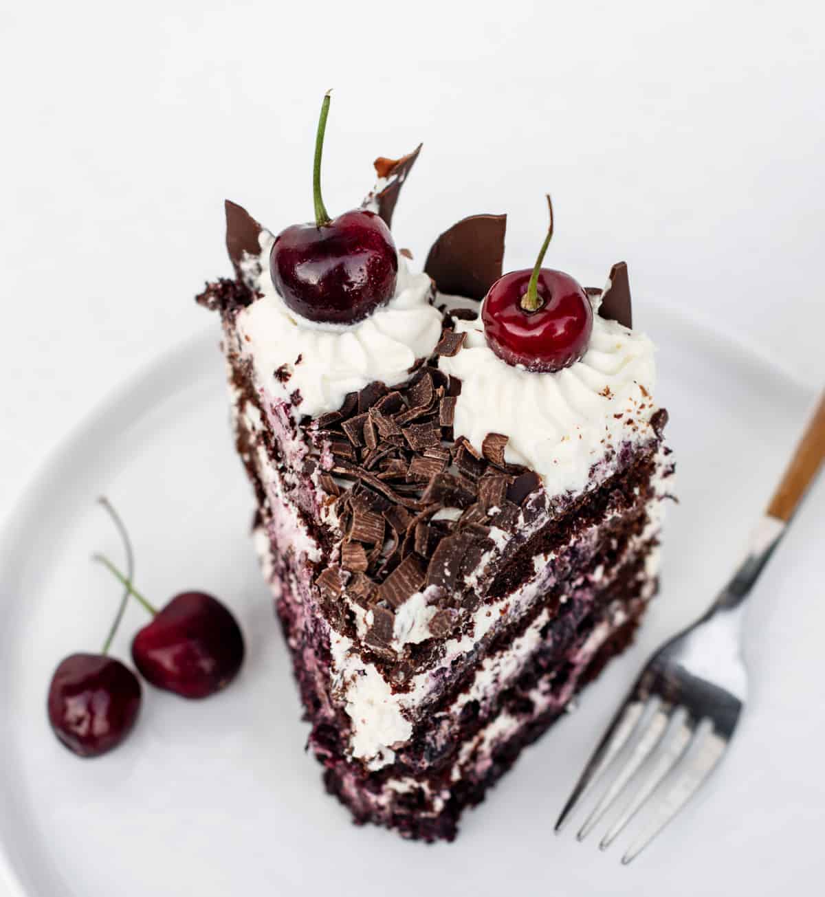 A slice of black forest cake on a white plate