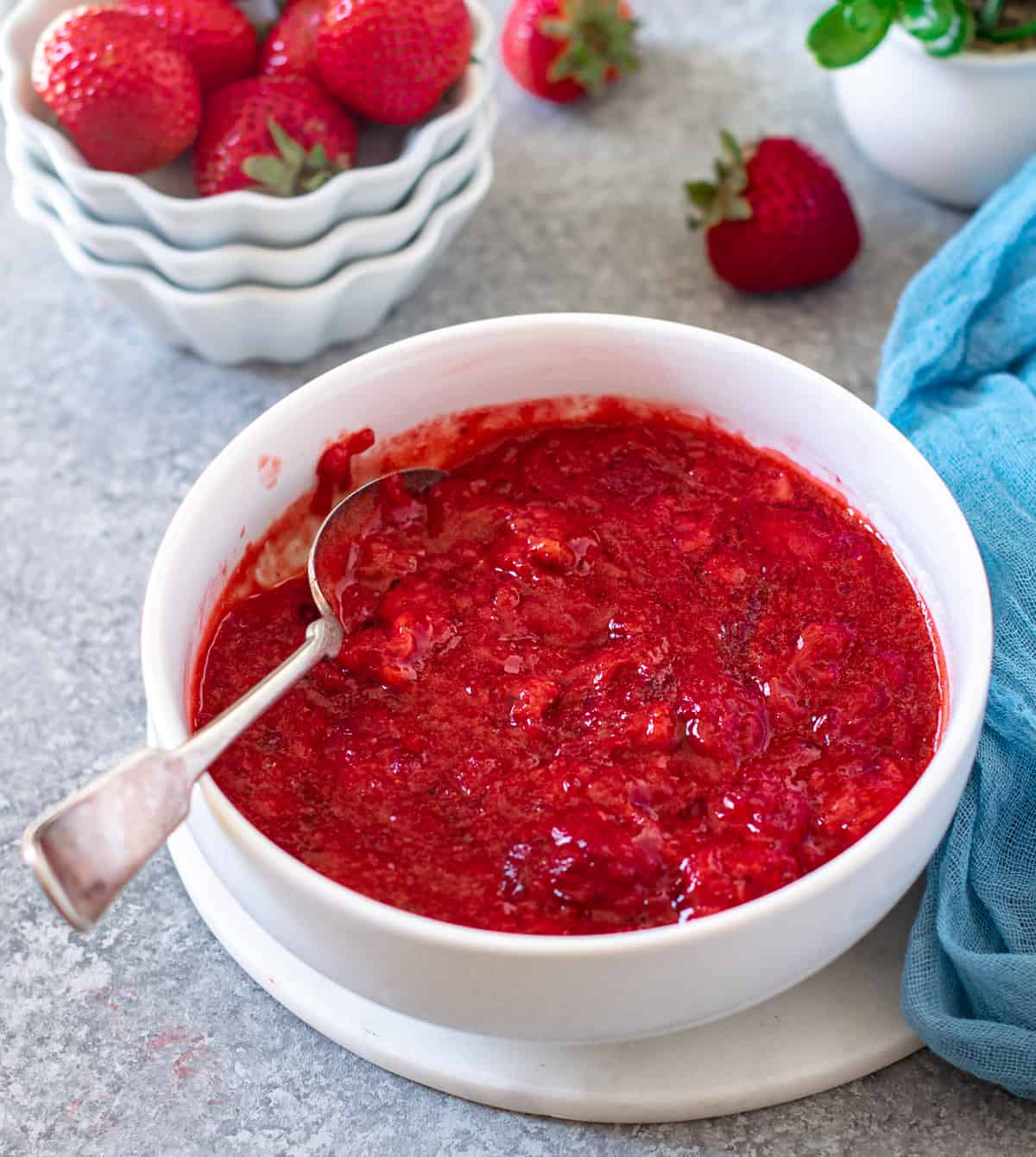 Strawberry filling in a white bowl with blue napkin