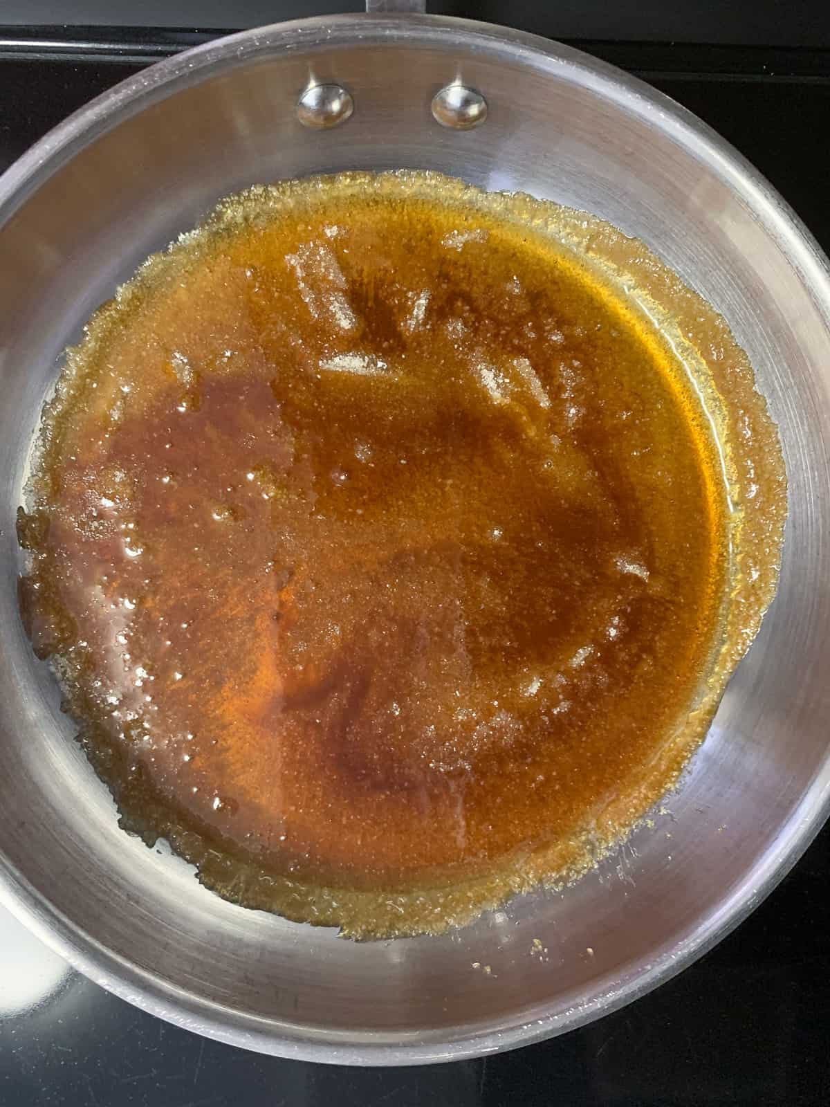 Sugar caramelizing in a wide bottom pan