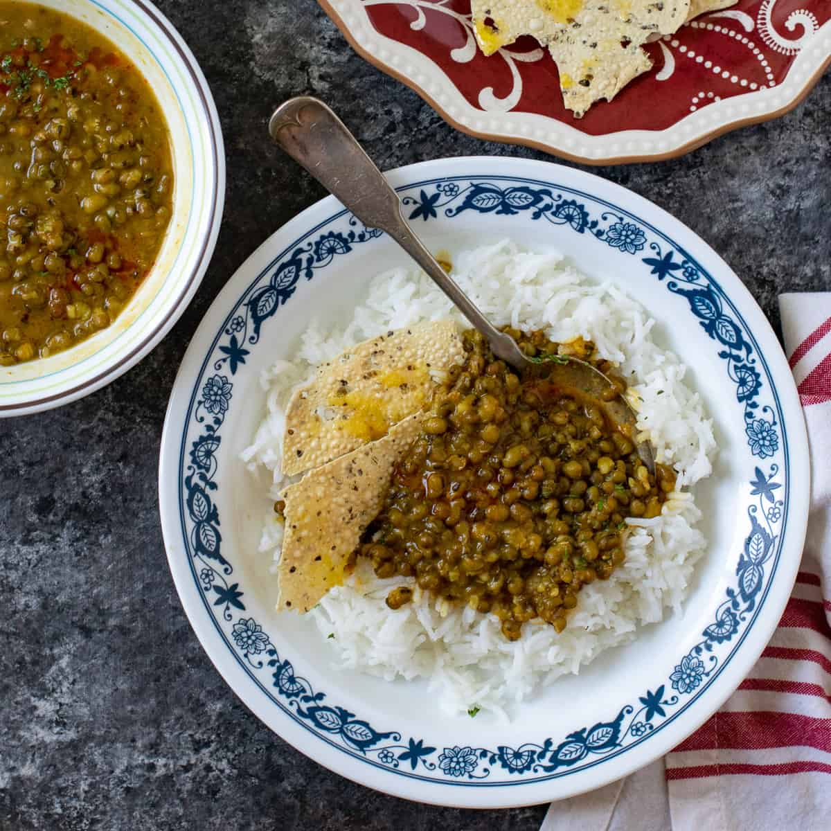 Green moong dal served with rice and papad