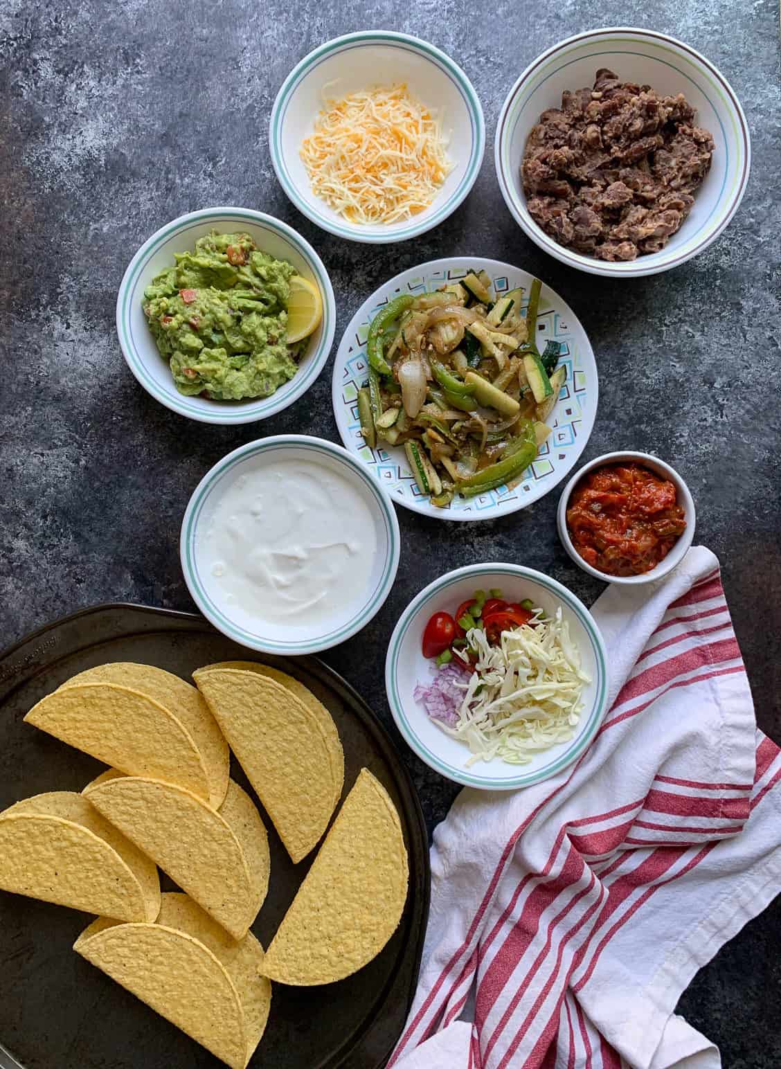 Ingredients to make tacos laid on a black board