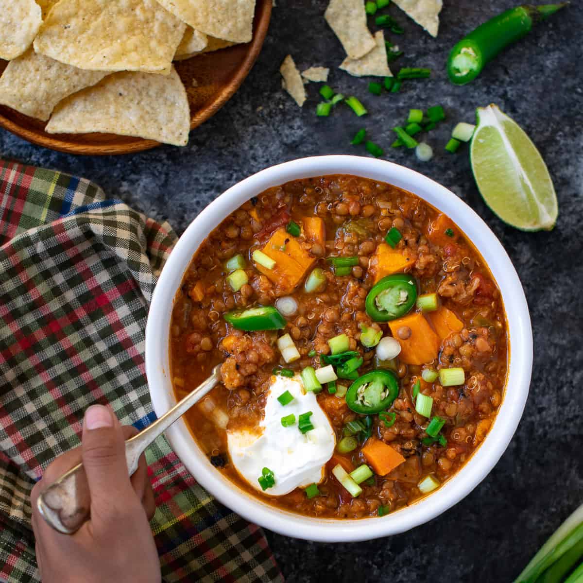Sweet Potato Quinoa Lentil Chili served in a white bowl and a spoon