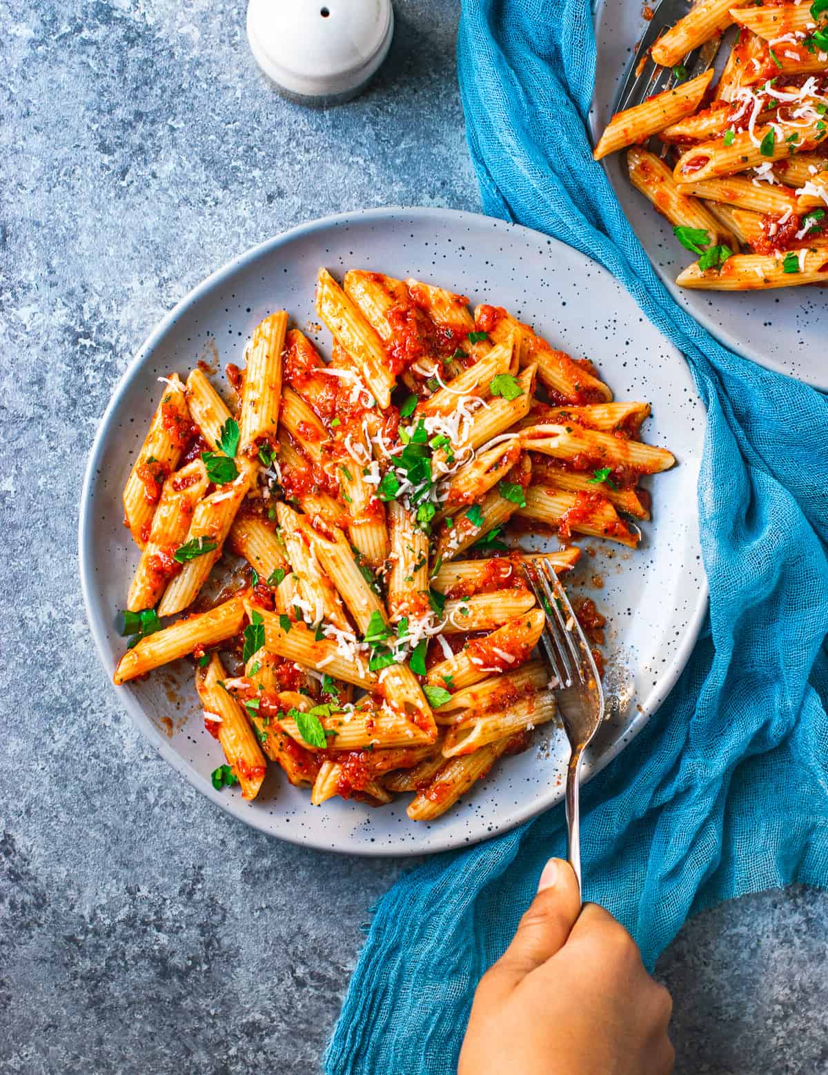 Roasted Red Pepper Sauce Pasta on a grey plate with a fork