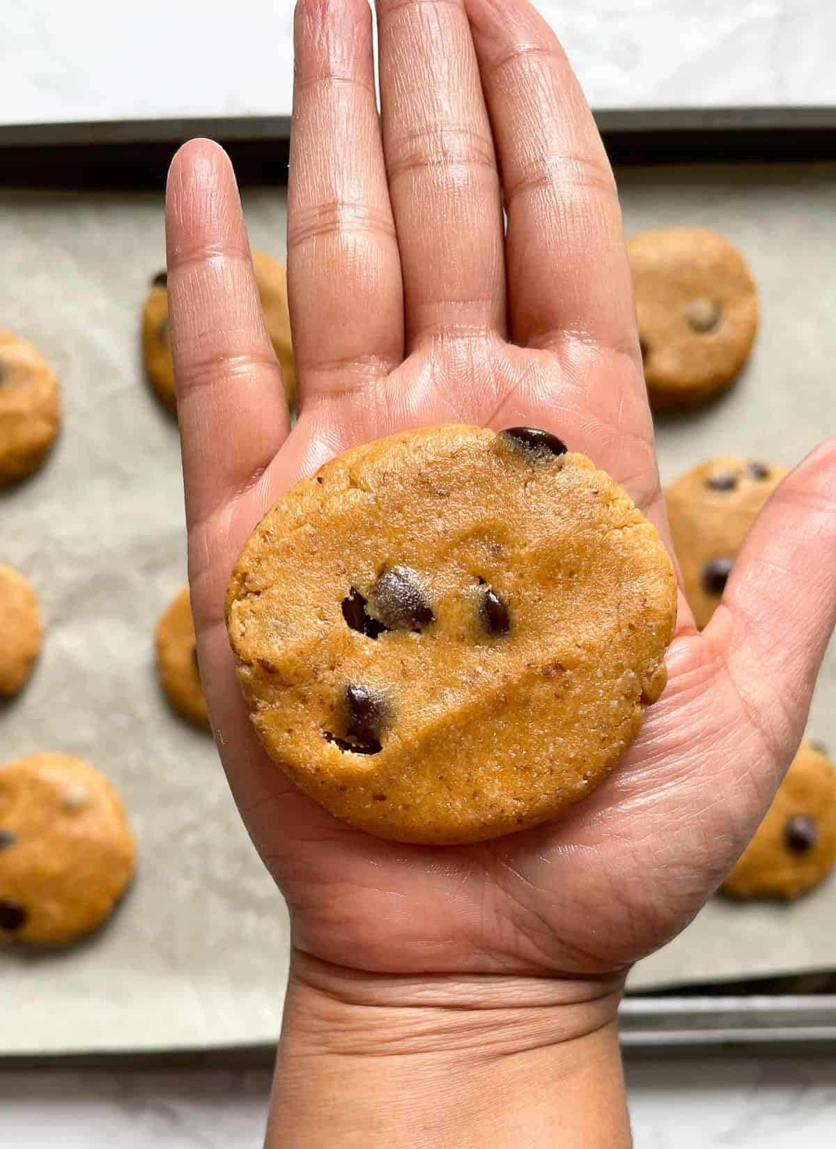 Flattening cookies on the palm