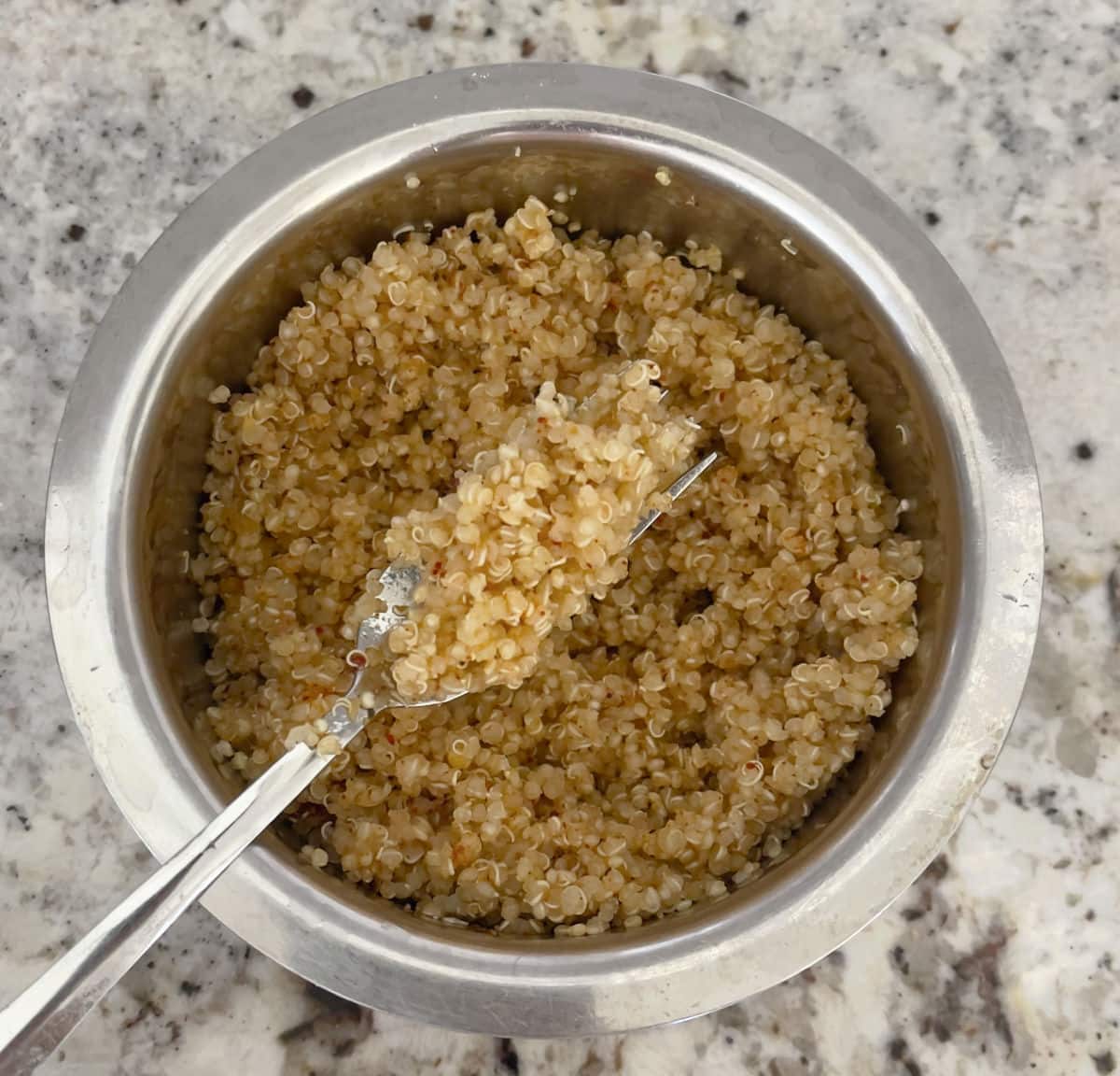 A bowl of quinoa with a fork 