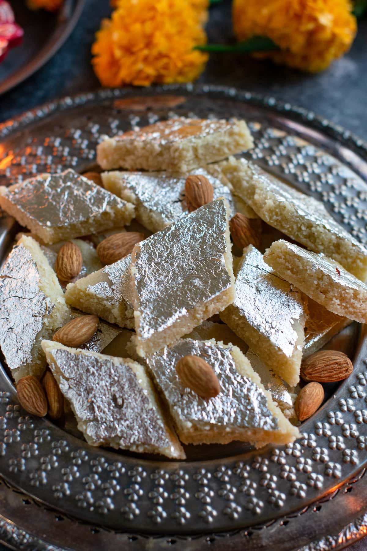Vegan Badam Katli placed on a plate and topped with almonds