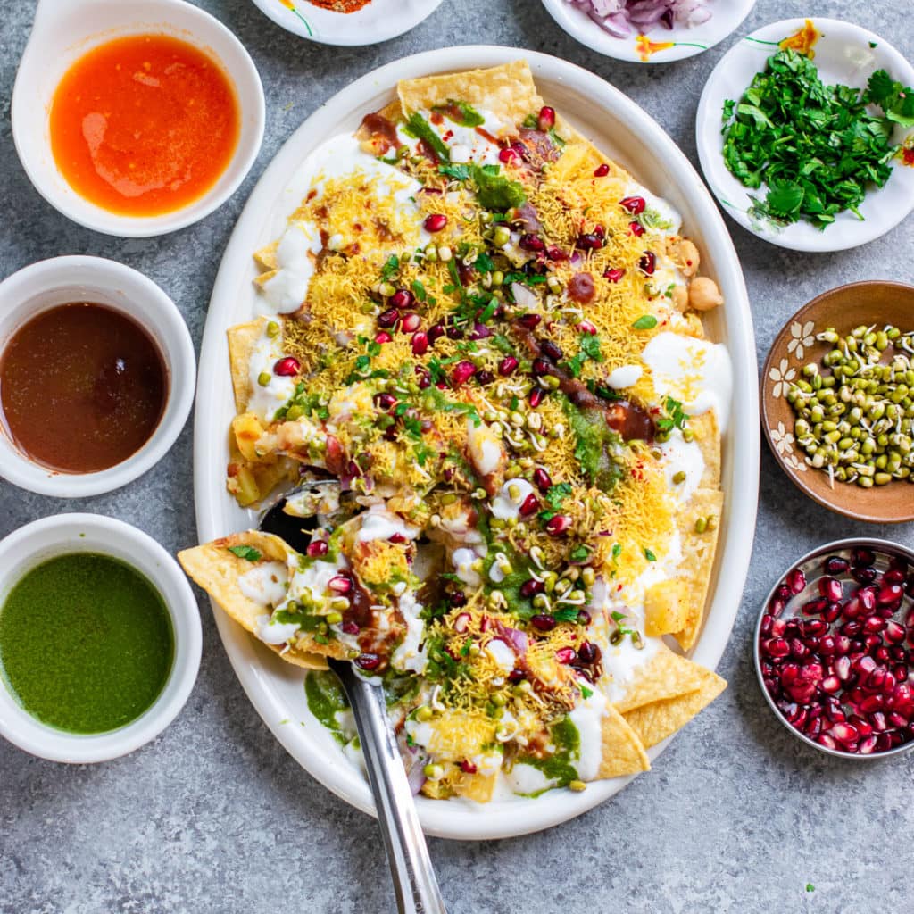 Dahi papdi chaat served with chutneys and toppings on the side. 