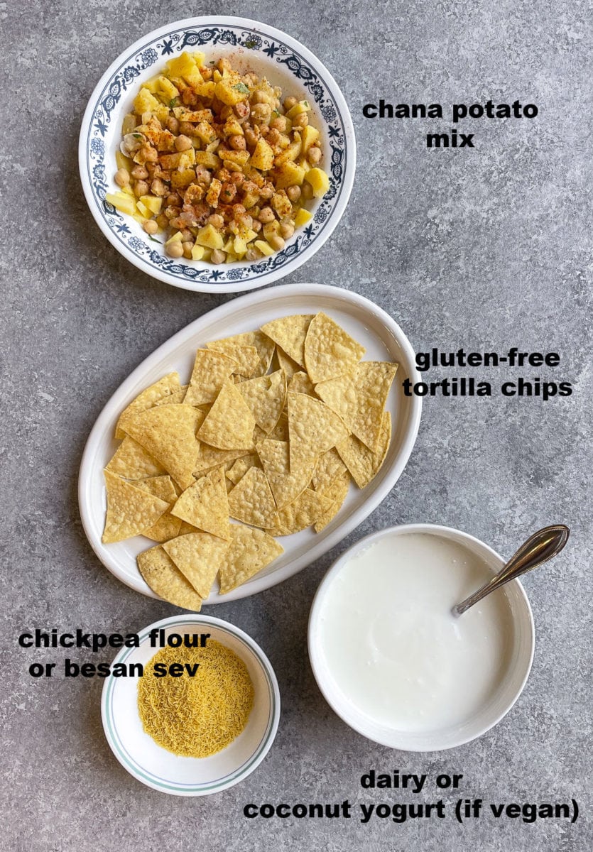 Ingredients to make papri chaat in different bowls. 