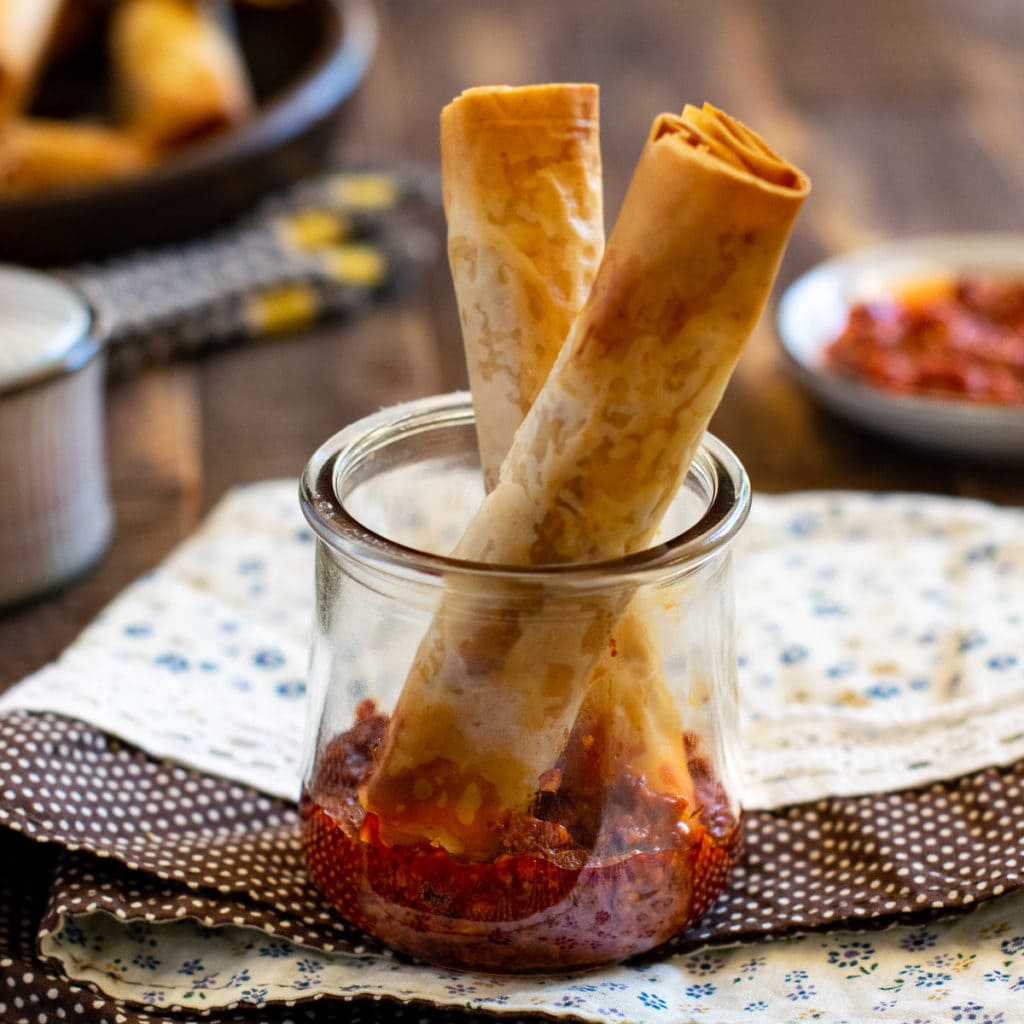 Crunchy paneer rolls tucked in the jar of Schezwan sauce. 