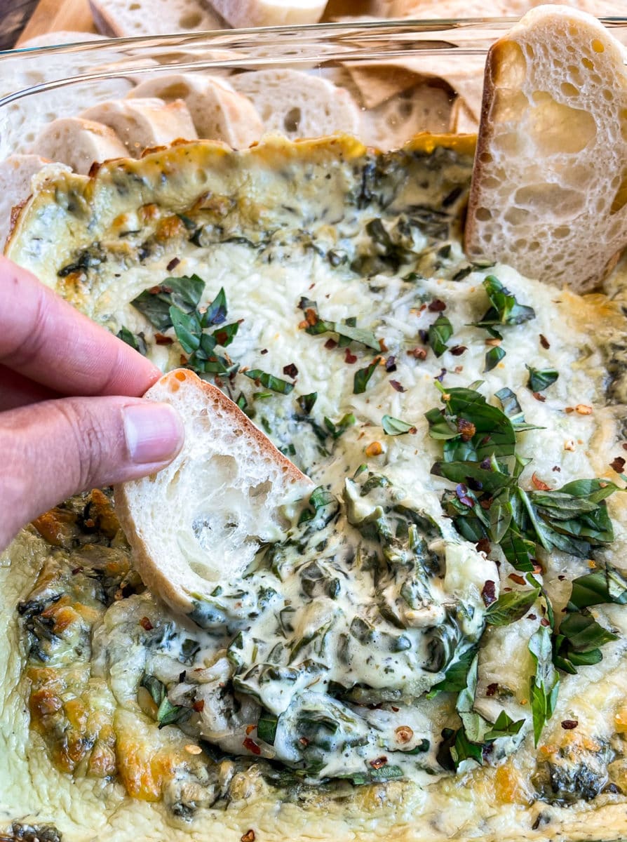 Jalapeno Spinach Cream Cheese Dip scooped with a crusty french bread.