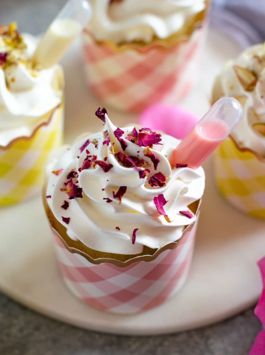Desi flavor cupcakes garnished with rose petals and rose milk pipette. 