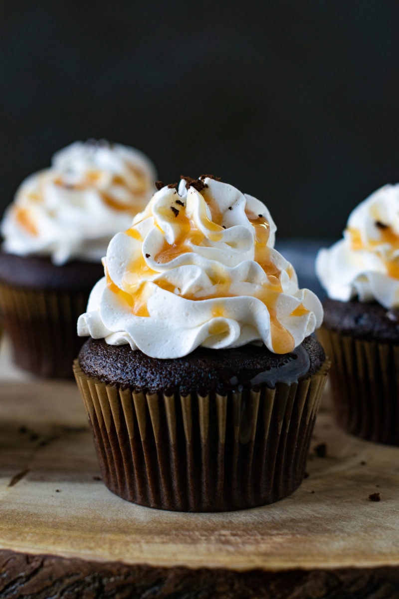 Eggless coffee cupcakes topped with cool whip cream and caramel sauce. 