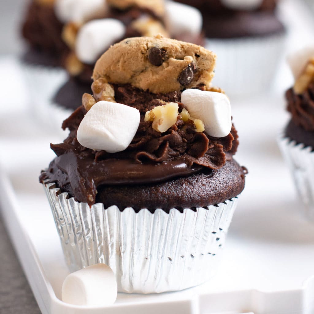 Ganache Filled Rocky Road Cupcakes set on a white tray.