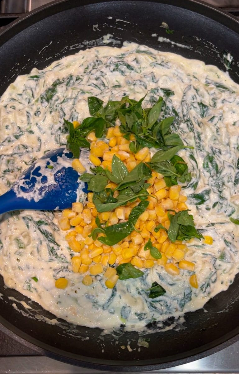 Spinach, sweet corn and ricotta filling cooked in a pan. 
