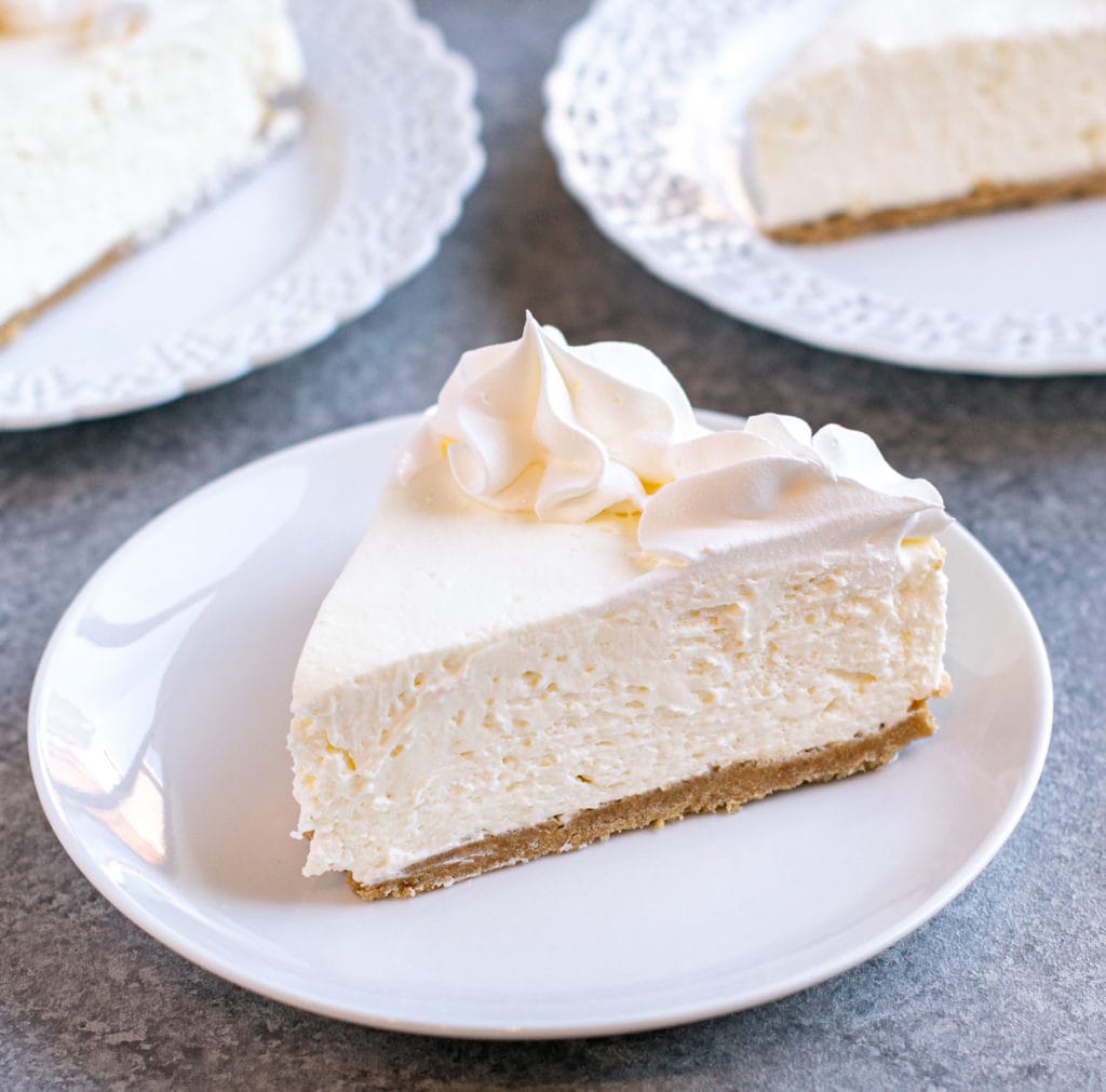 A slice of no-bake cheesecake on a white plate. 