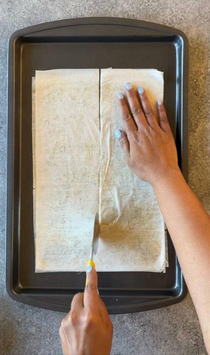 Cutting the phyllo dough into equal parts.