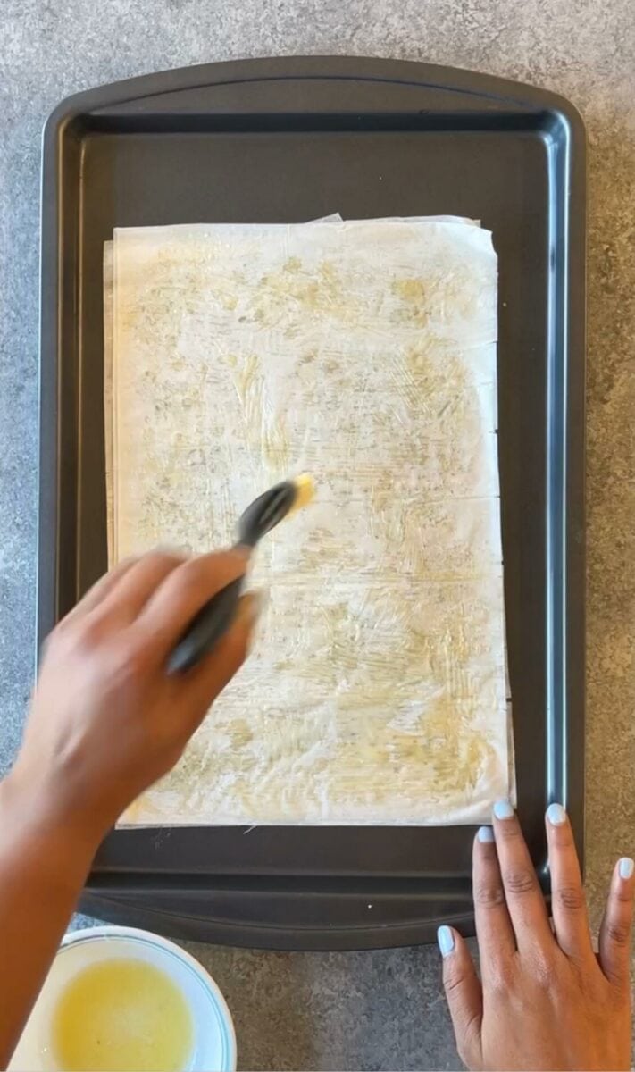 Brushing phyllo dough with butter.