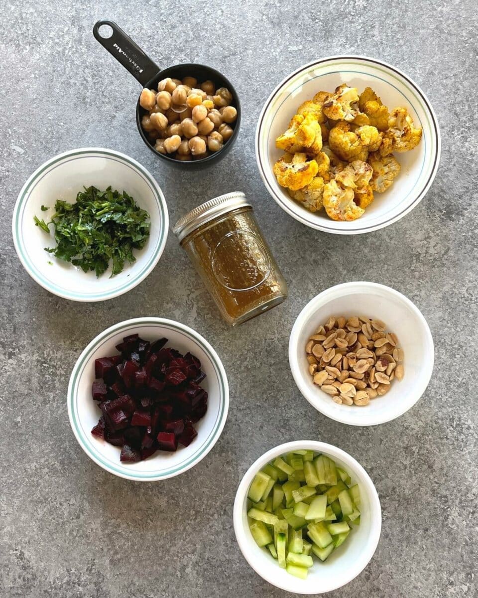 Ingredients to make cauliflower chickpea salad with spicy Indian dressing. 