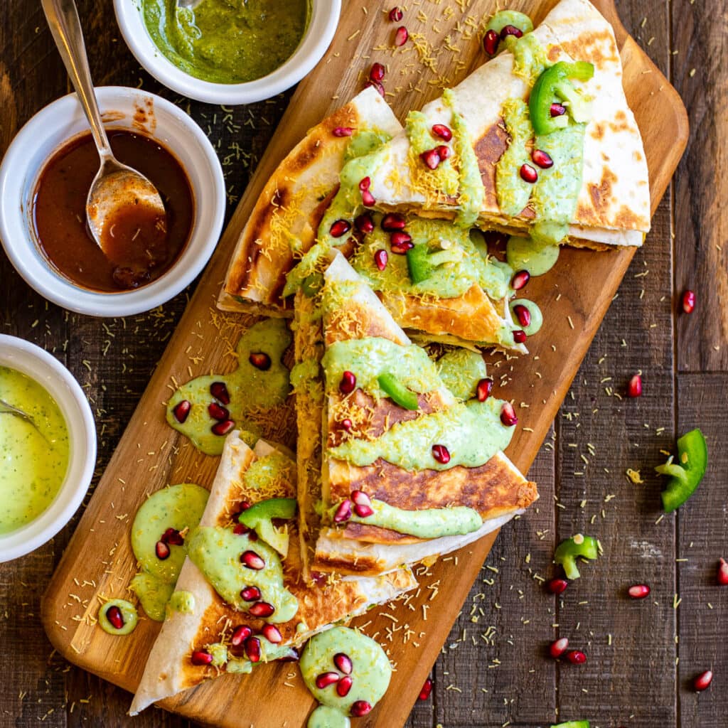 Samosa wraps served with chutneys on the side.