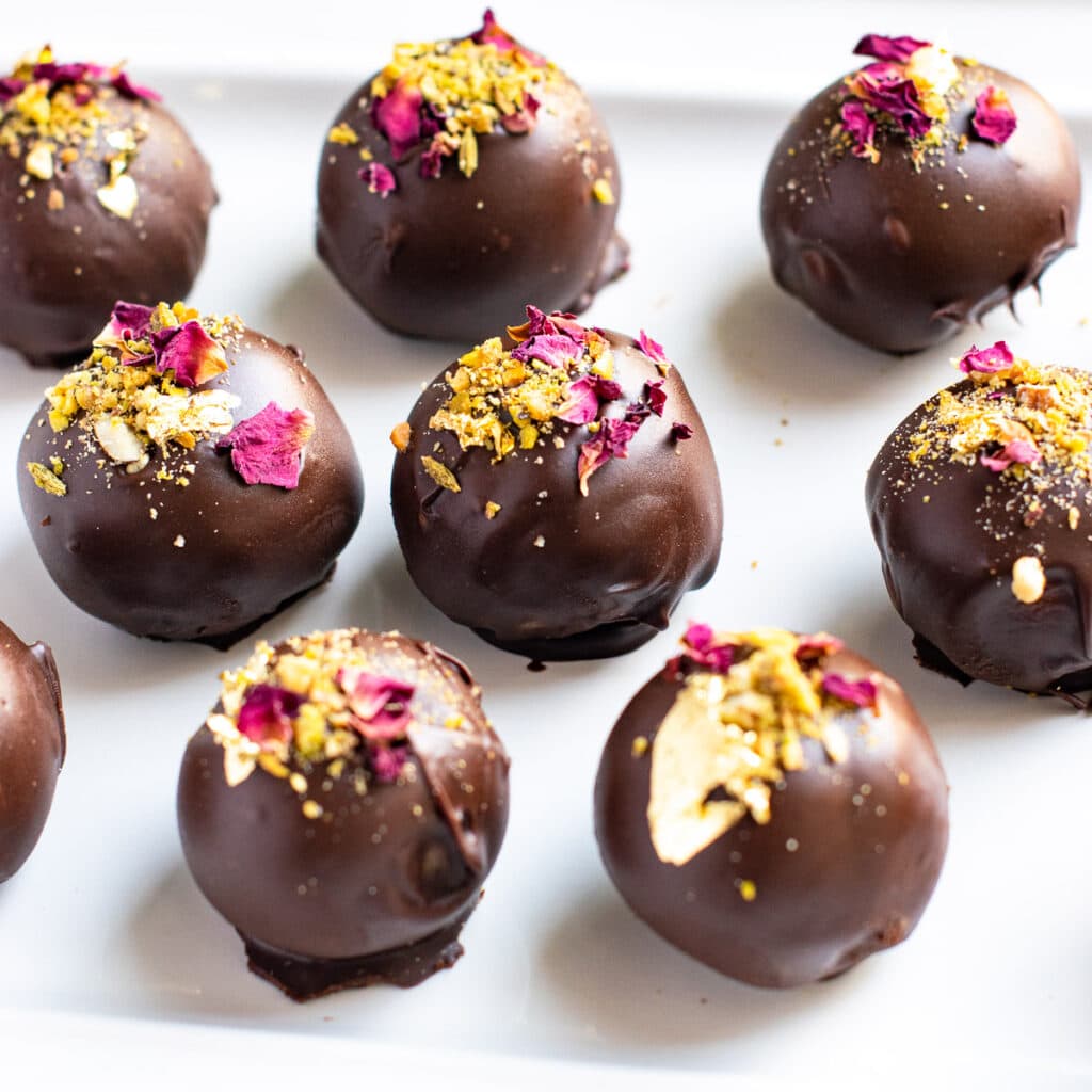 Almond rose truffles garnished with crushed nuts. 