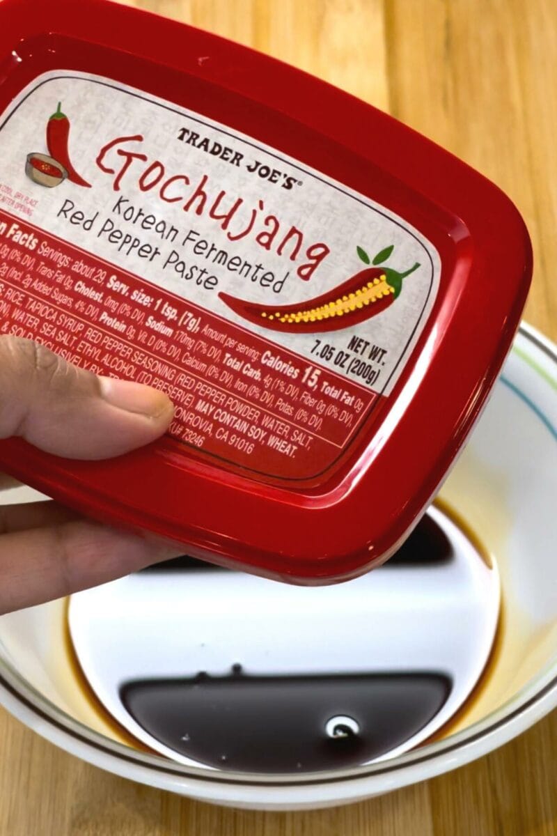 Adding gochujang paste to make the stir-fry sauce.