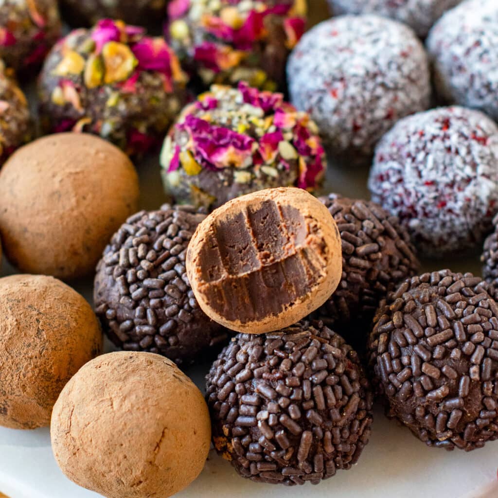 Homemade chocolate truffles in variety of toppings like cocoa, nuts, coconut. 