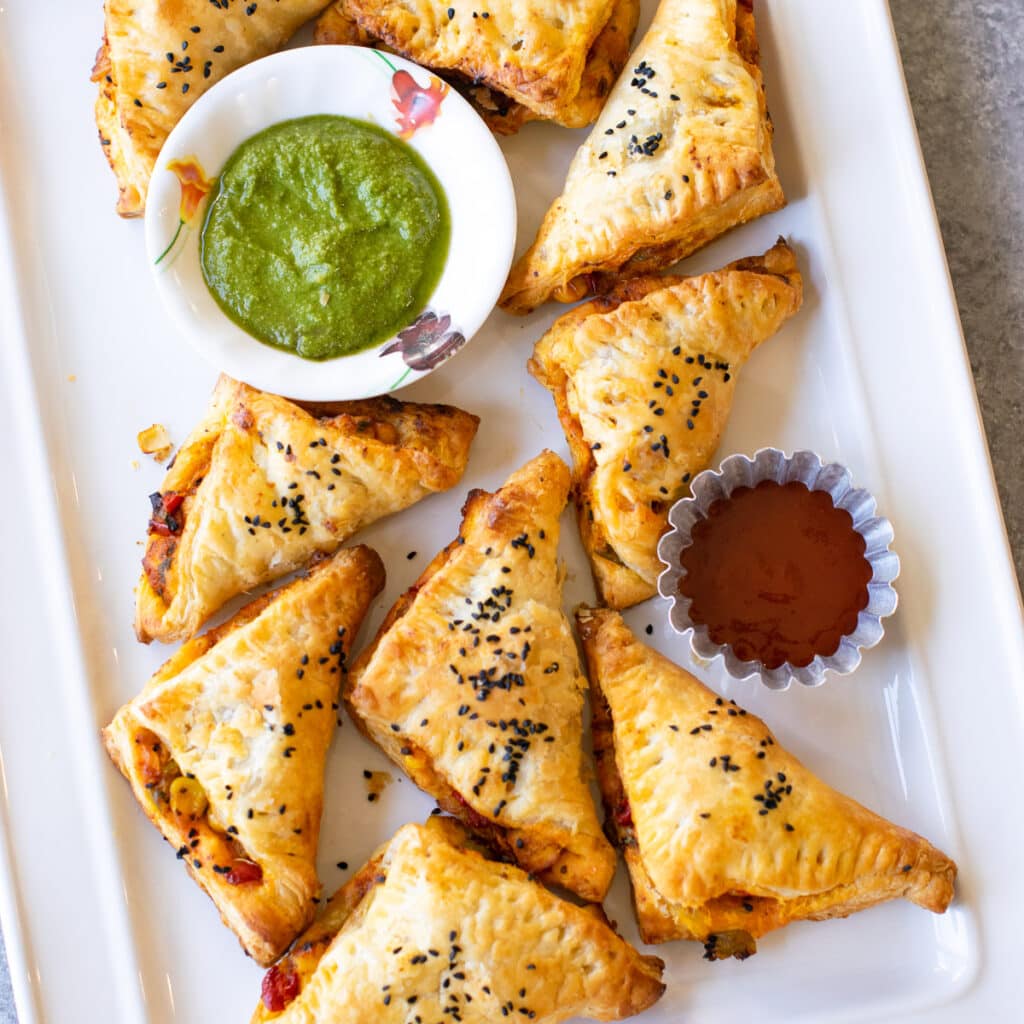 Spicy paneer puffs served with green chutney and ketchup. 