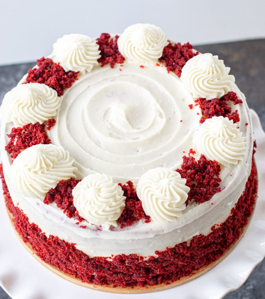 Red velvet cake decorated with cream cheese frosting. 
